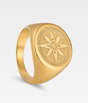 Klackring - signet - kompass i guld färg